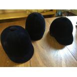 Three riding hats sizes as shown unused.