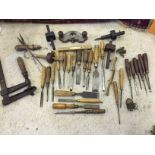 Old tools including a quantity of woodworking chisels.