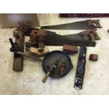 A selection of old hand tools including several saws wooden planes a hand drill and others.