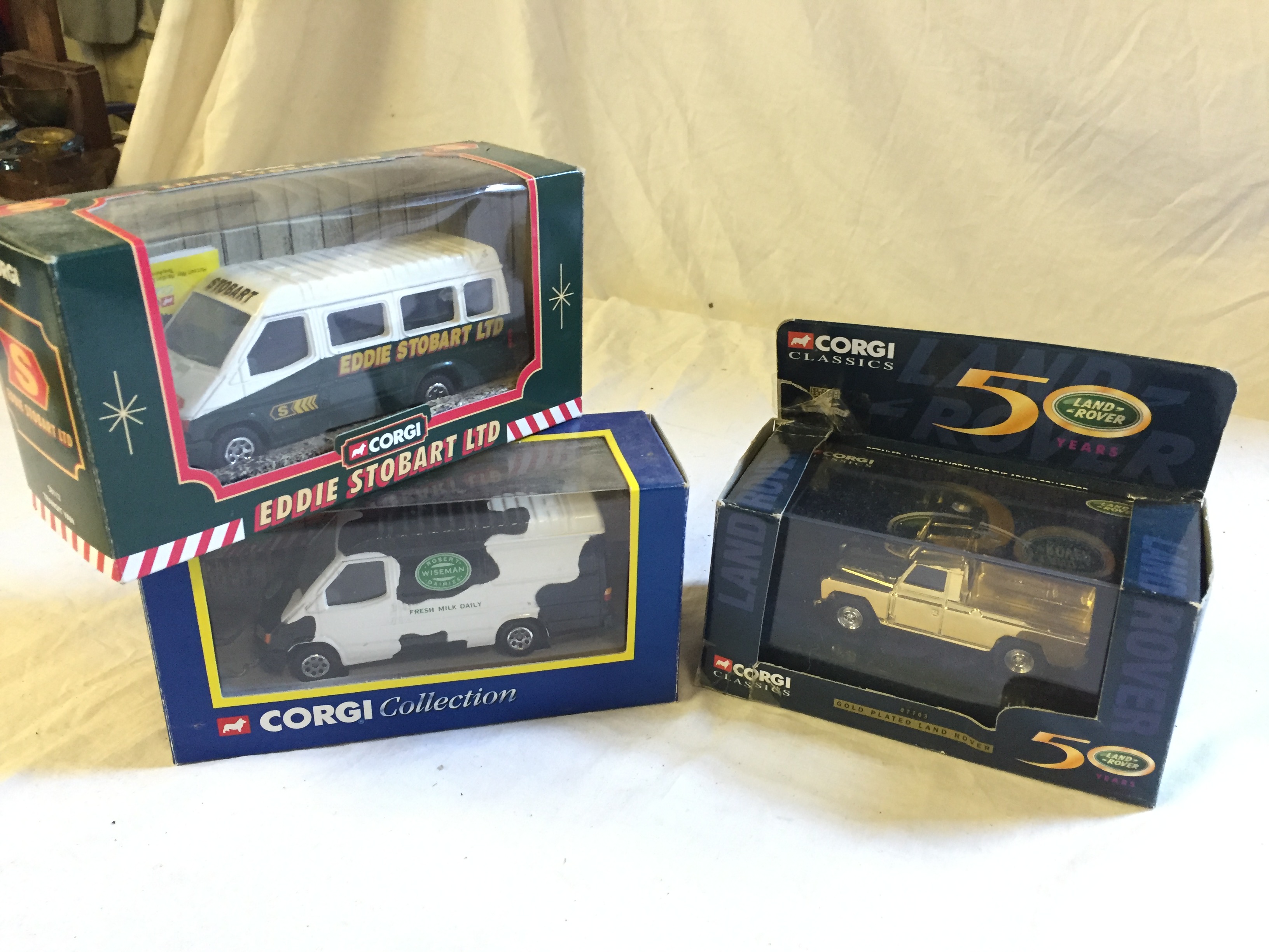 Three Corgi boxed toys Land Rover 50 years Eddie Stobart Van and Wiseman's Dairy.