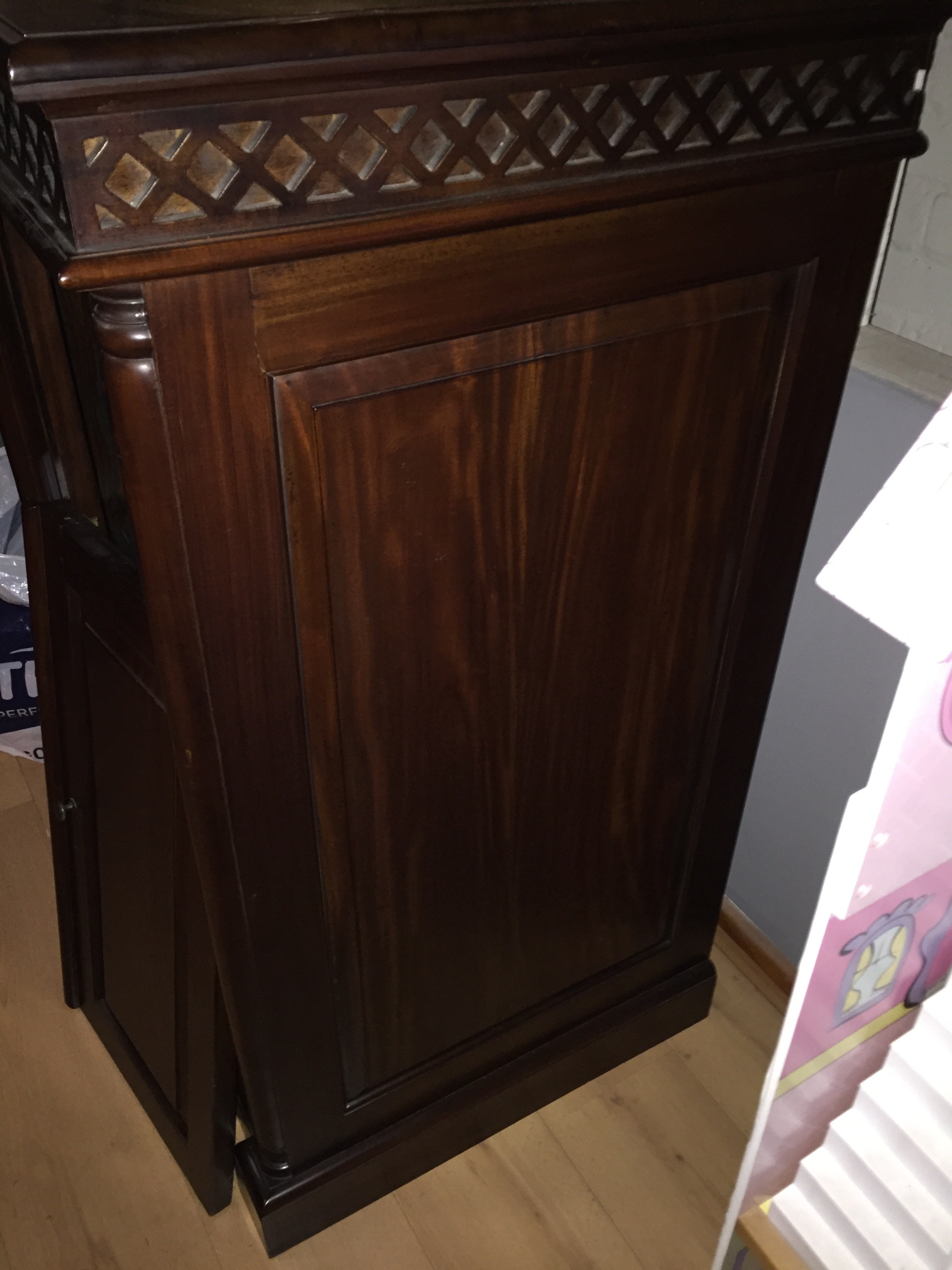 A dark wood television cabinet with drawer beneath. Needs slight repair to door.