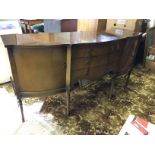 A sideboard with three central drawers and two side cupboards.