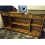 A low sideboard with three drawers over shelves.