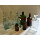 Eleven Vintage bottles including green chemist bottle with stopper, brown bottles,