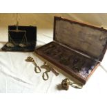 A boxed set of weighing and a boxed set of brass novelty keyrings.