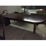 A large mahogany winding dining table 760 mm x 2730 mm x 1100 mm.