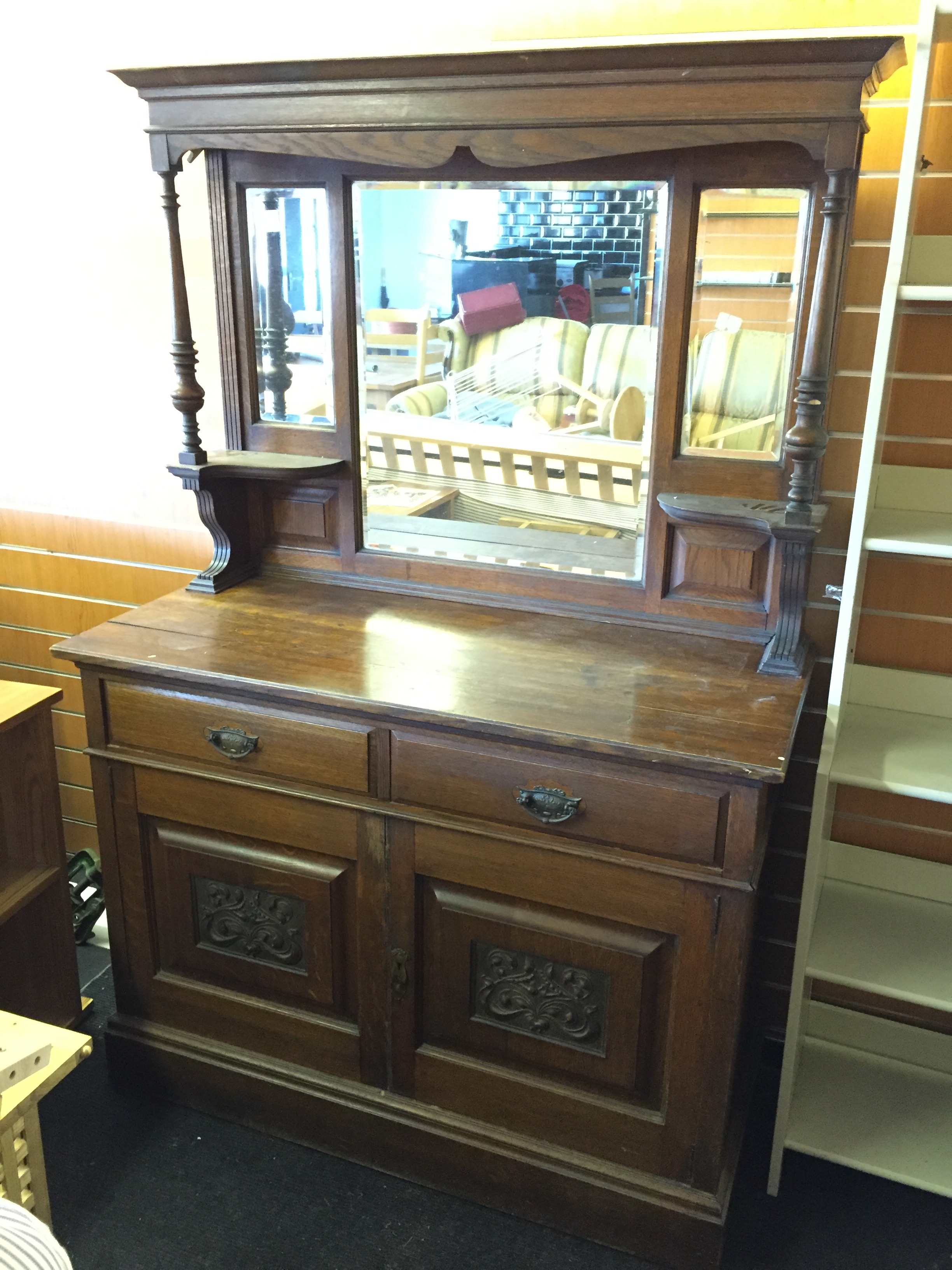 A mirror backed sideboard,