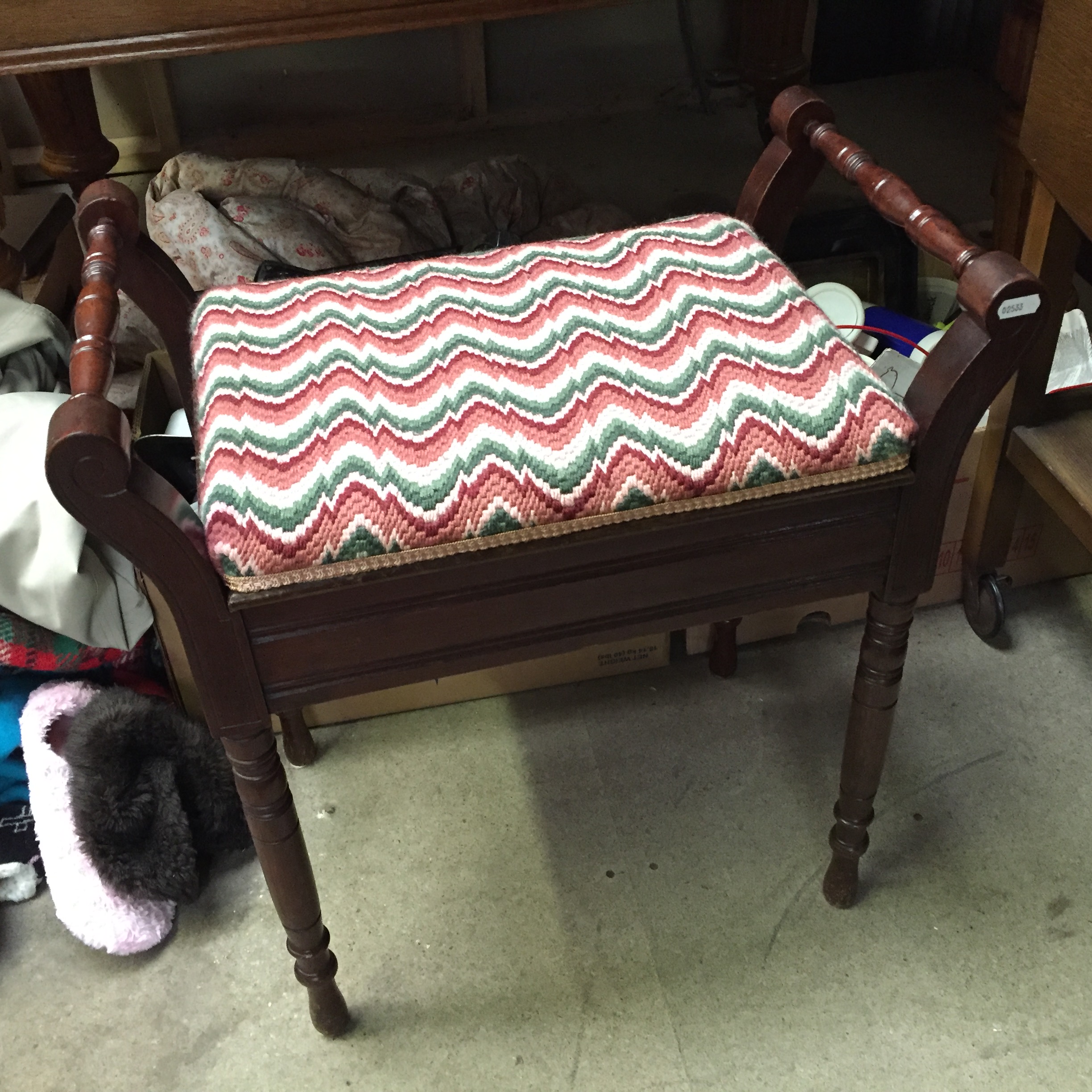 A Victorian mahogany piano stool with upholstered seat.