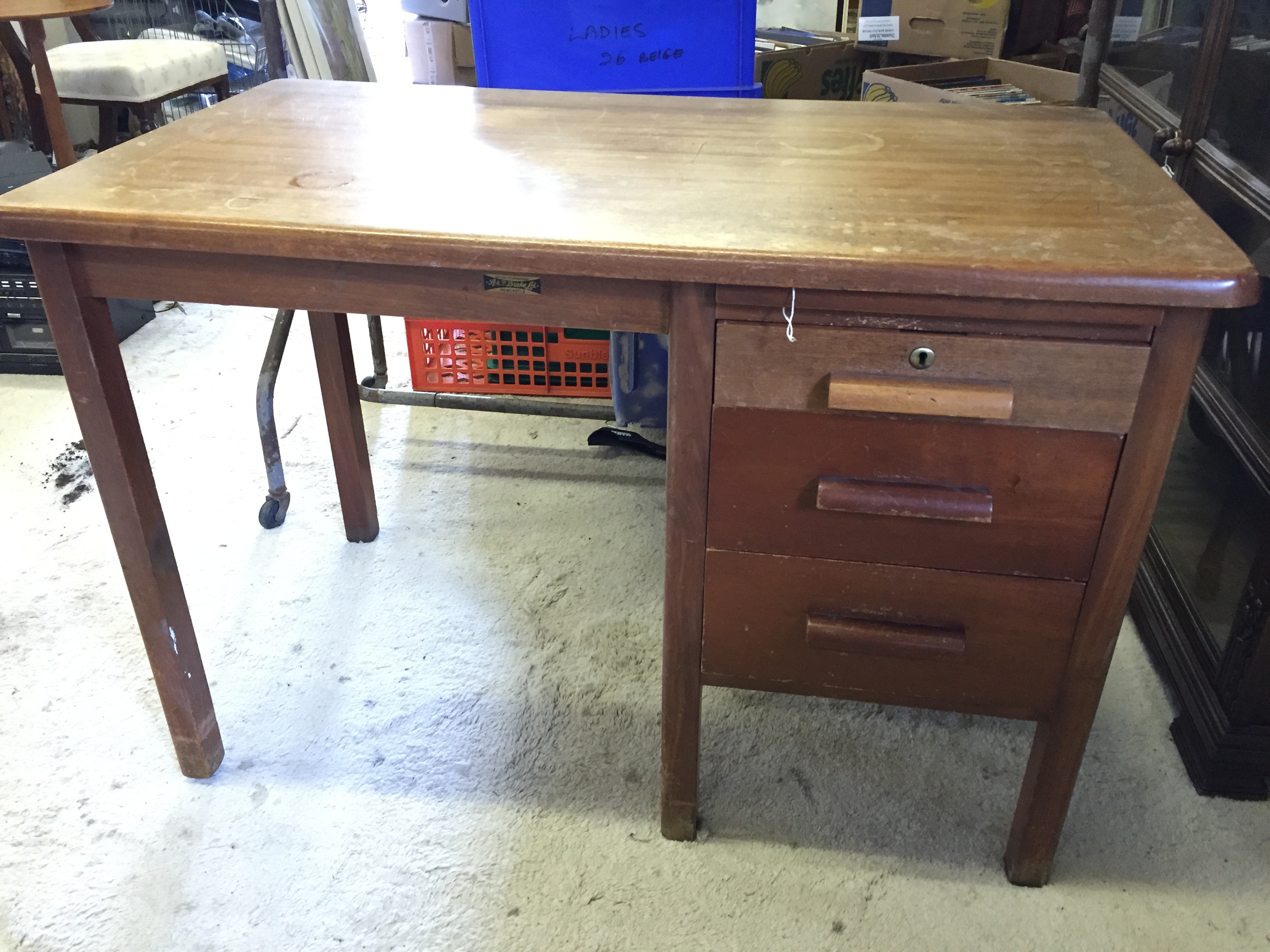 An office desk with three side drawers.