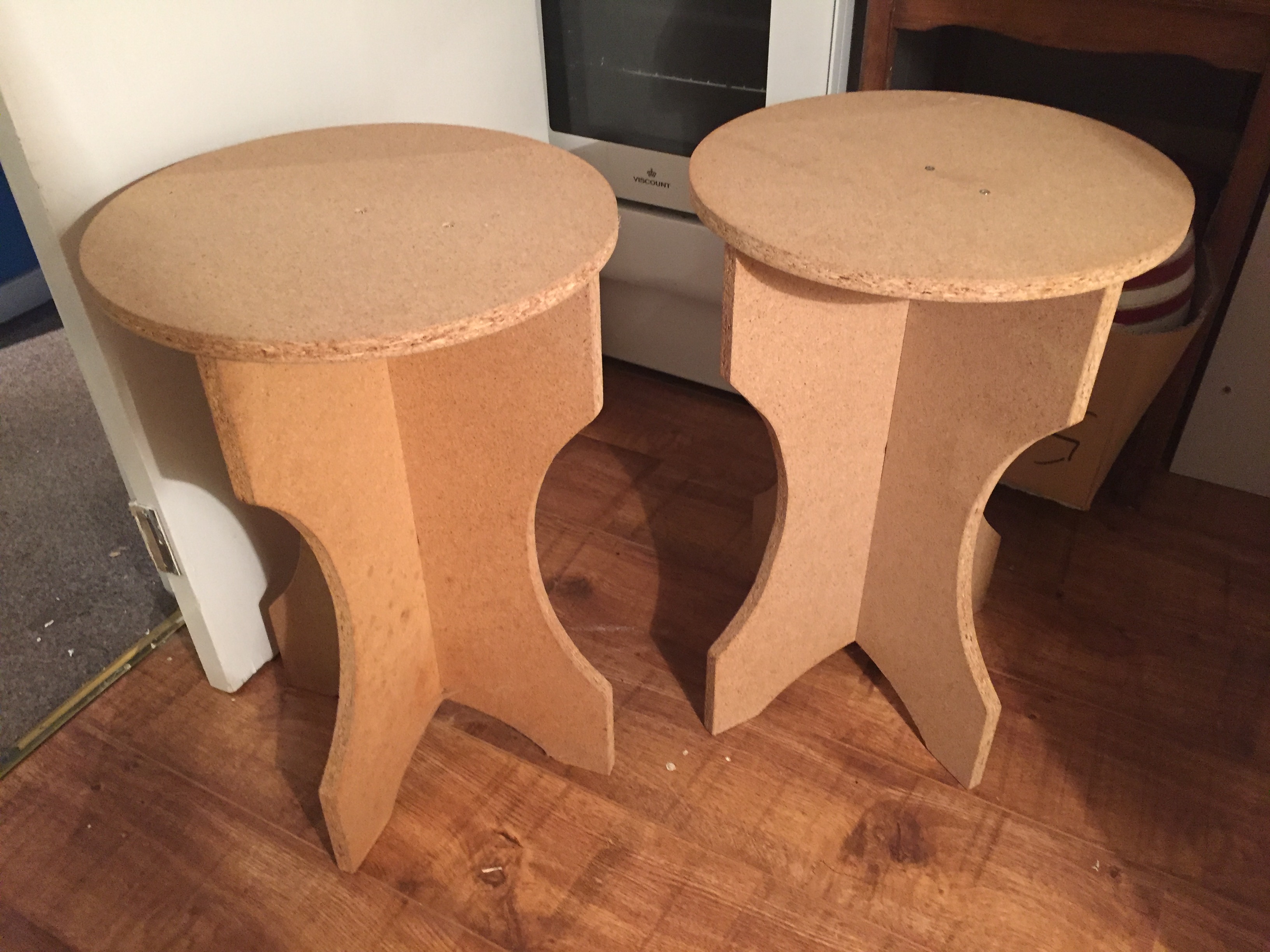 Two chipboard tables.