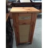 A pine cupboard with single drawer above.
