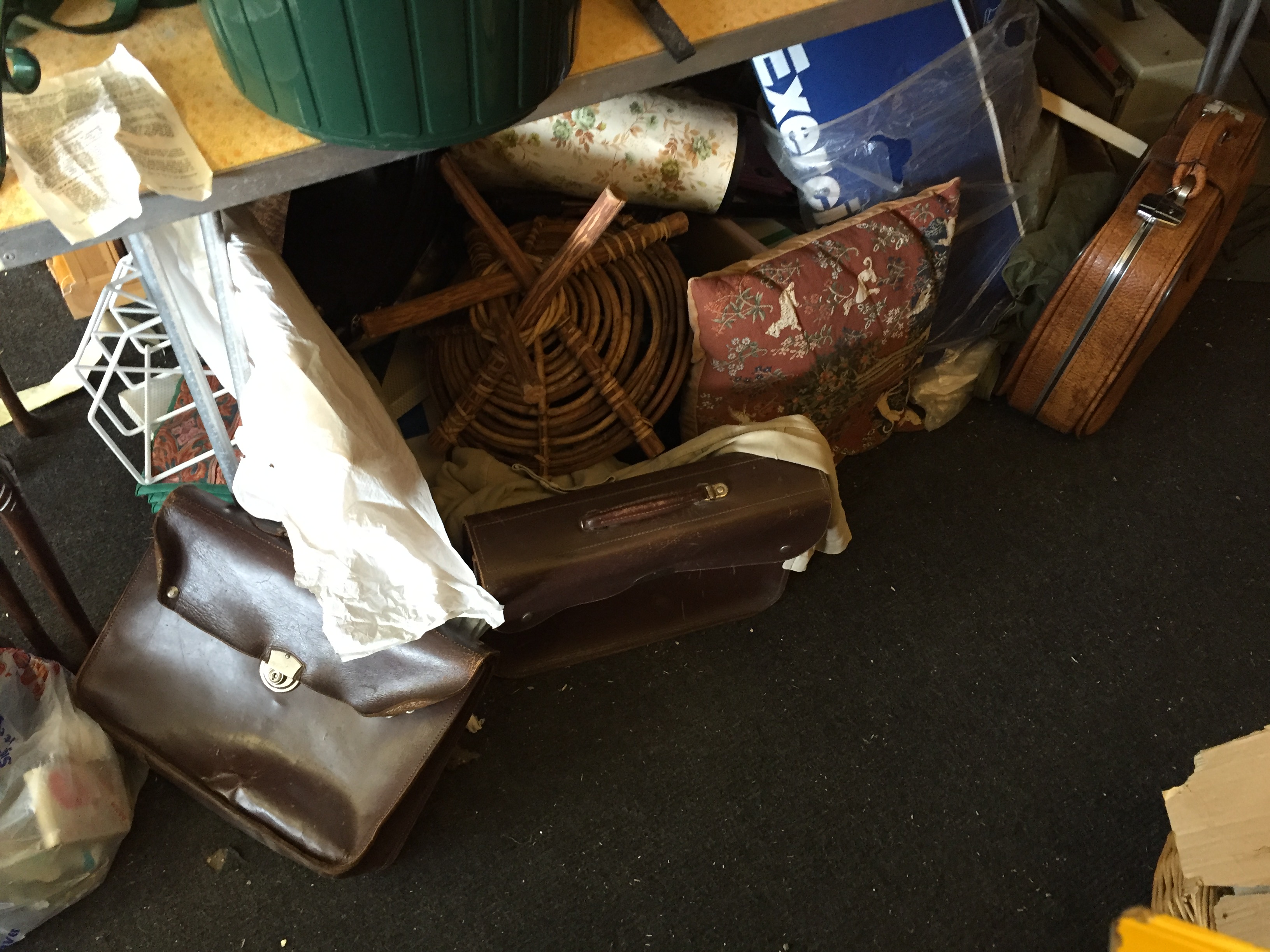 A lot under the table including leather satchels, a tool box glass vases and much much more.