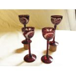 Four Bohemian ruby etched liquor glasses.