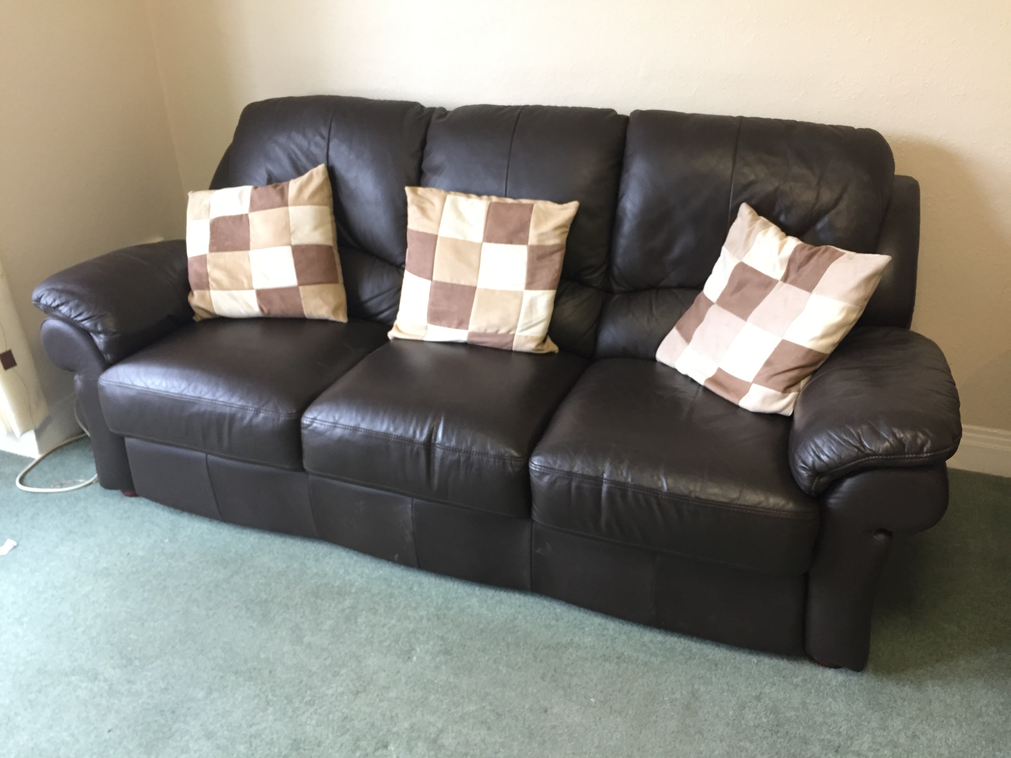 A leather Three seater settee.