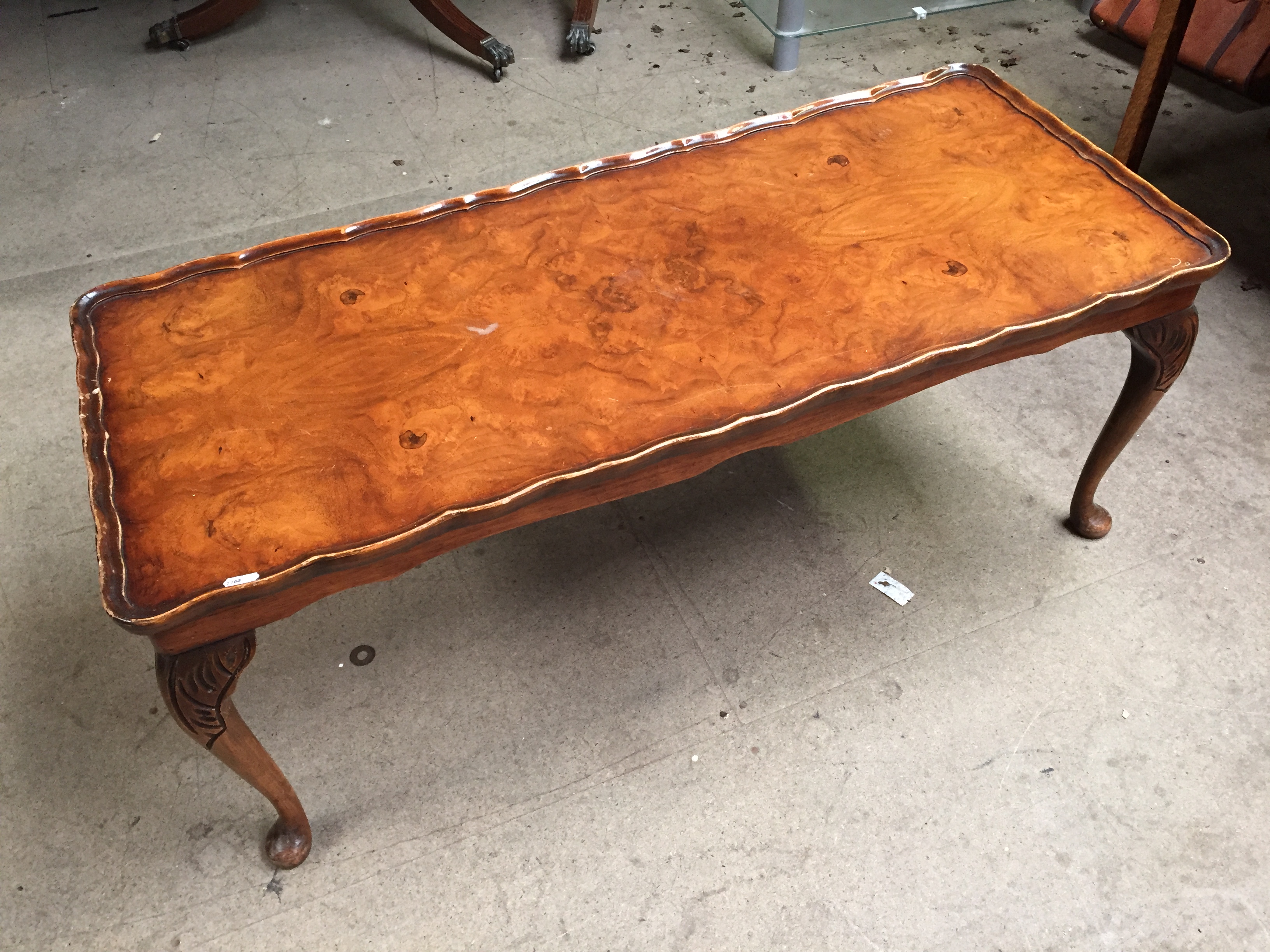 A pie crust coffee table with Queen Anne legs.