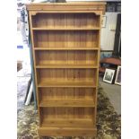 A six shelf pine bookcase.