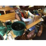 A Lot of stuff onthe table, ceramics, a foot pump,Vintage suitcases, a dager.