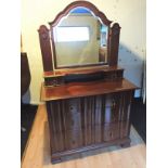 A dressing table with three long drawers with drop handles.