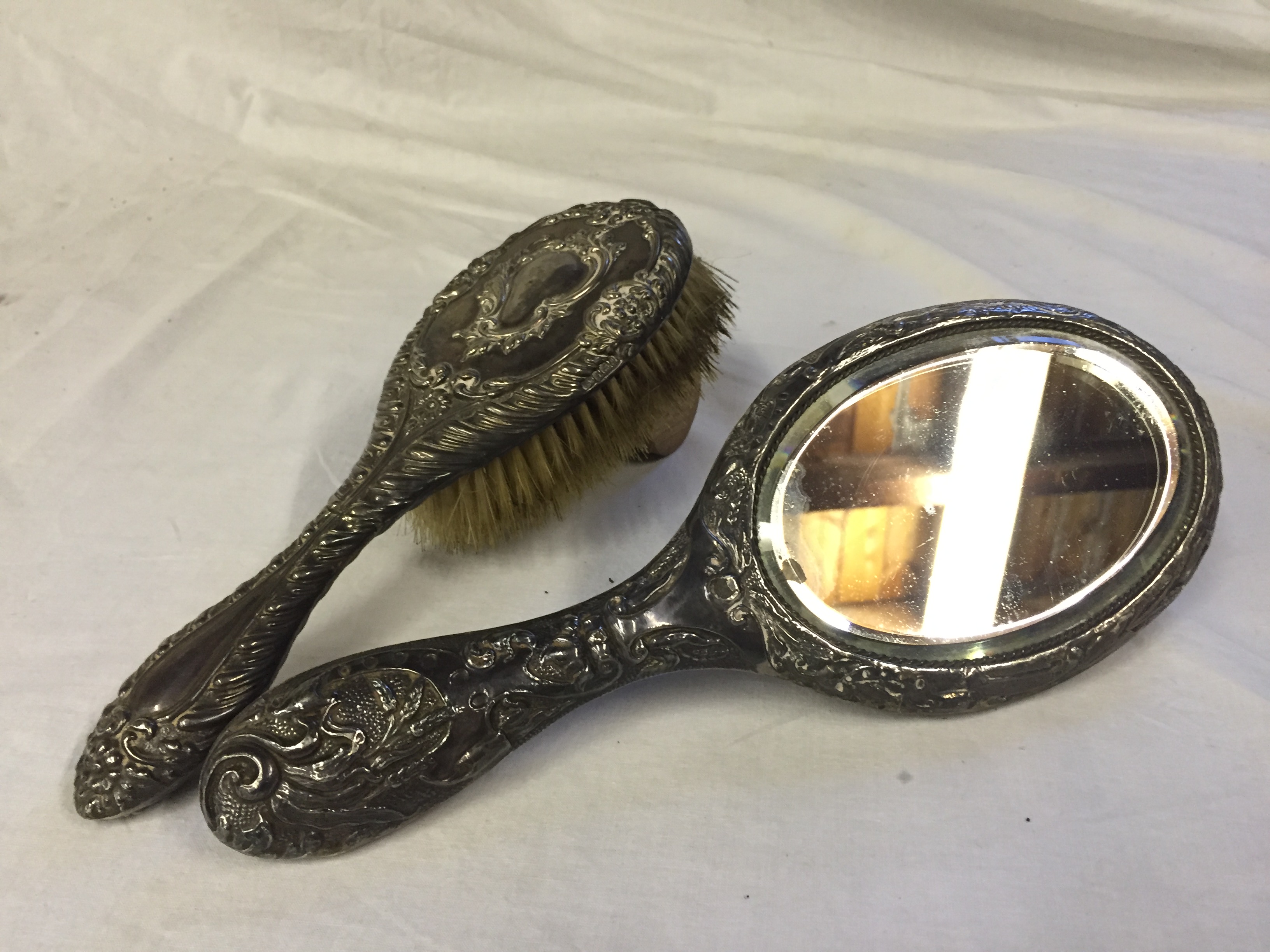A sterling silver hairbrush and mirror.