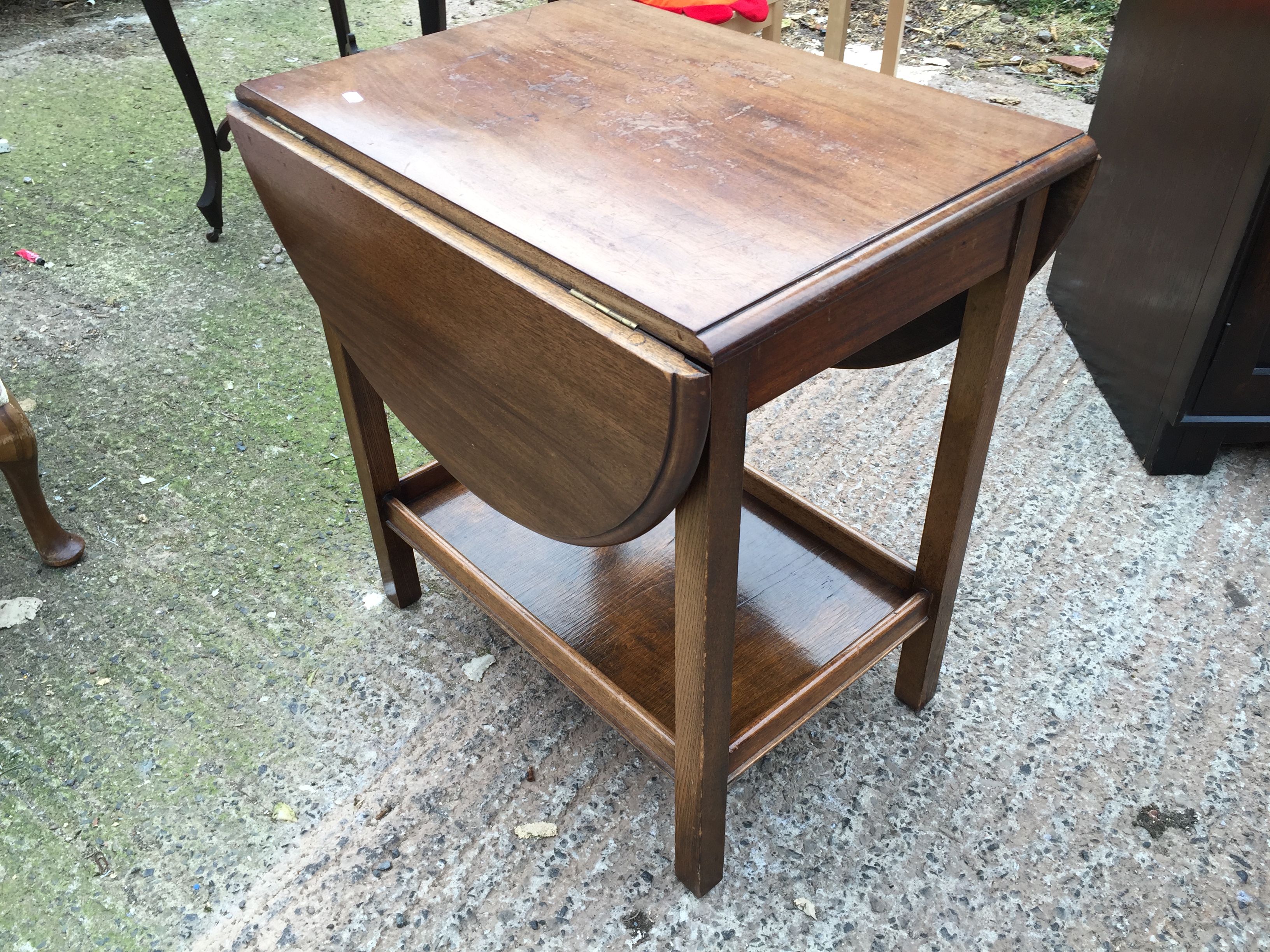 A drop leaf side table with shelf.