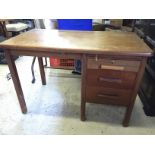 An office desk with three side drawers.