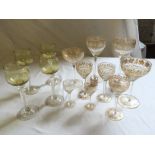 Nine gilt decorated hand blown glasses and four air twist wine glasses.