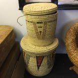 Two large wicker baskets with lids.