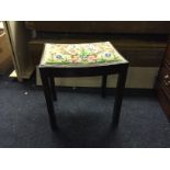 A piano / dressing table stool with hand embroidered seat.