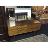 A mid century dressing table with two sets of three drawers and triple mirrors.