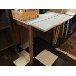 A mid century blue formica drop leaf kitchen table.