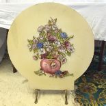 A fire screen with raised still life vase of flowers decoration.