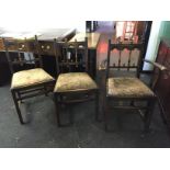 Three Ercol cathedral style dining chairs.