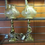 A pair of brass lamps.