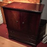 A television cabinet in dark wood.