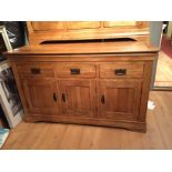 An as new oak sideboard having three dra