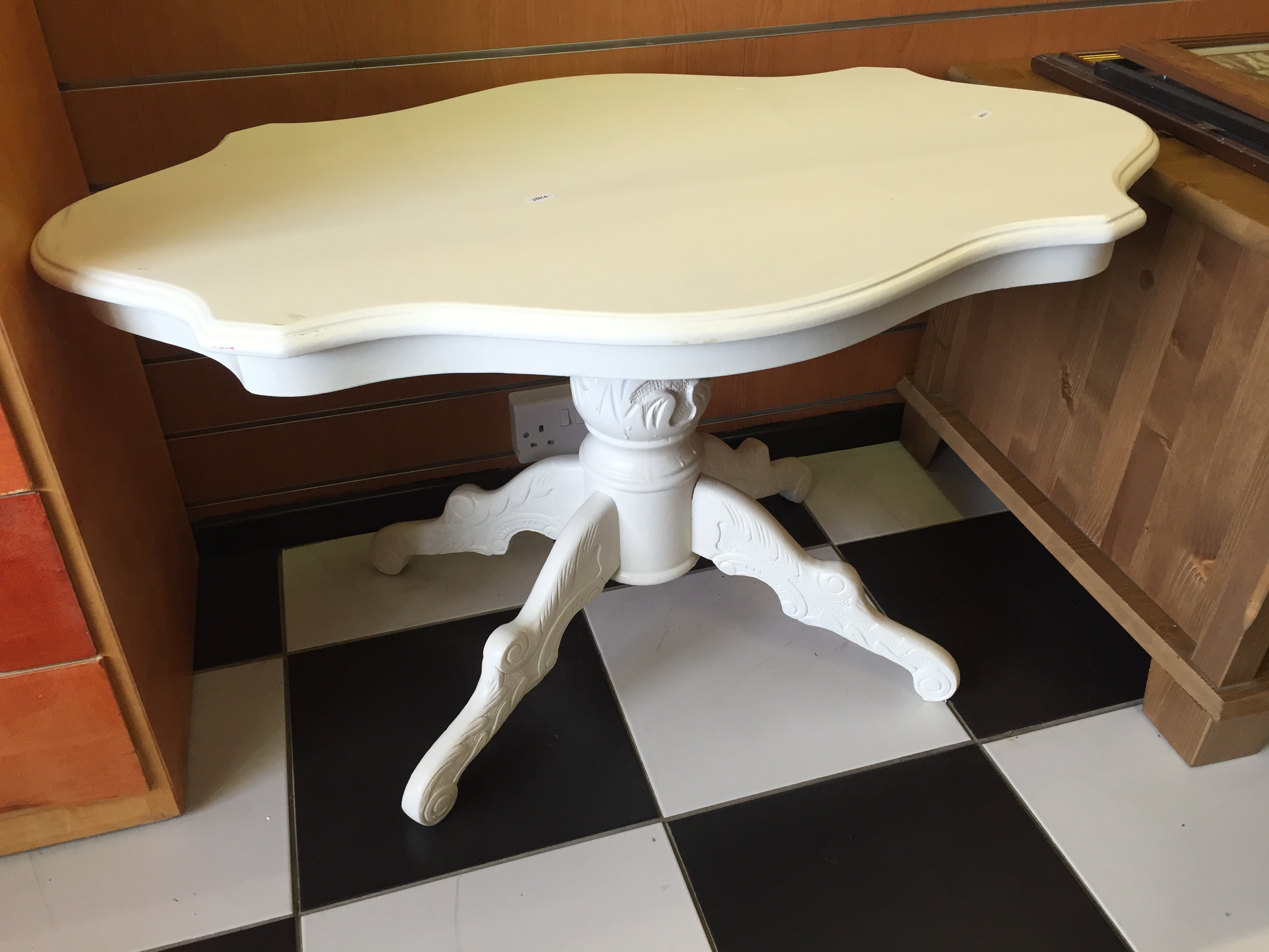 A low white painted ocasional table.