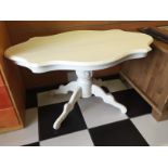 A low white painted ocasional table.