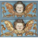 Zwei barocke Putti-Köpfe. Reliefs.56 cm x 26 cm. Holz geschnitzt. Farbig gefasst, Reste von