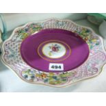 A decorative 19th century Herend plate painted with a floral medallion against a puce ground, floral
