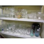 Two shelves of glassware to include champagne flutes, sherry glasses, wine glasses, shot glasses,