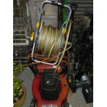 A Mountfield petrol mower, plus a Hozelock hose and reel, plus a quantity of tools, spades, loppers,