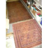 An old Turkoman rug, the brown ground with two lines of octagons and an old Turkoman mat.