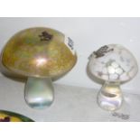 Two modern iridescent glass toadstools, each applied with a metal frog, the larger signed J
