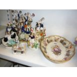 A collection of six Victorian Staffordshire figures, some with animals, a similar clock group, and a