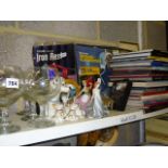 Four shelves of decorative items including framed pictures, a small quantity of records, brass table