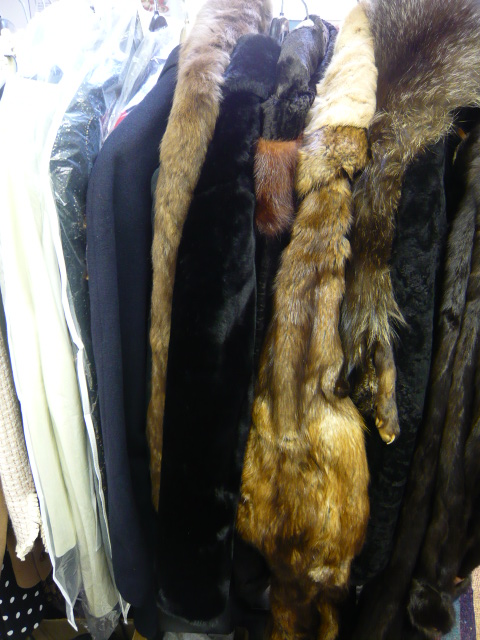 Five assorted fur, furry and fur-trimmed coats, a black gents dress suit, a woollen overcoat, and