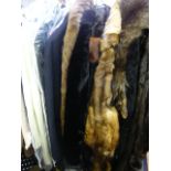 Five assorted fur, furry and fur-trimmed coats, a black gents dress suit, a woollen overcoat, and