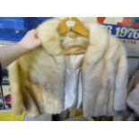 A pale blonde mink fur cropped shrug jacket with narrow collar  (upstairs rail by silver shelves)