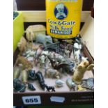 A vintage Cow & Gate Milk Food tin, a small collection of lead animals including an eagle, cows,