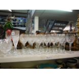 An extensive suite of glassware across two shelves to include red and white wine glasses,